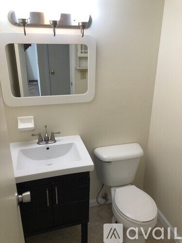 A white sink and toilet in a small bathroom.