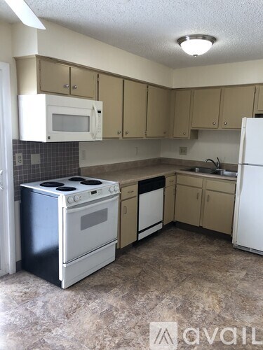A kitchen with a black stove and white oven.