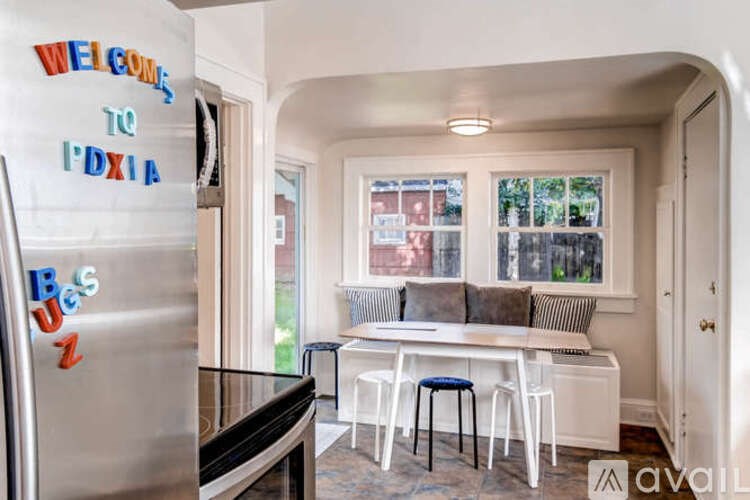 A kitchen with a fridge that has a sign on it that says "Welcome to PDX1A".