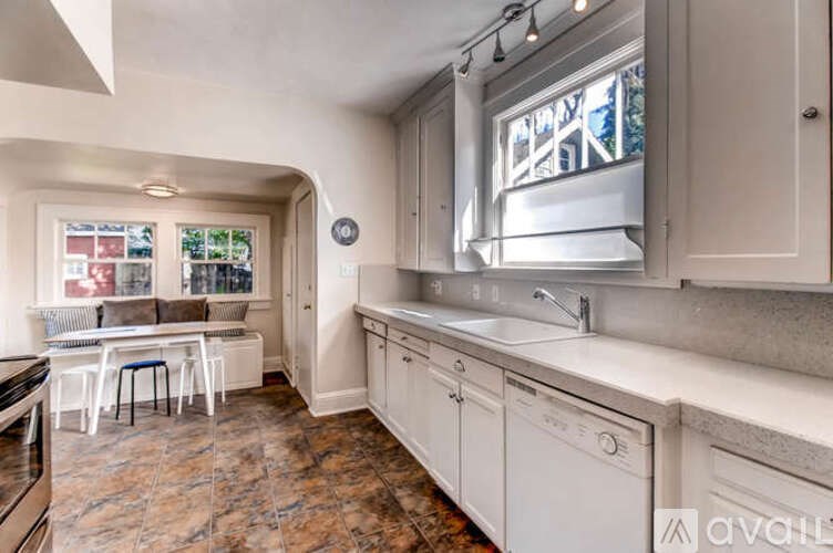 A kitchen with a washer and dryer built into the cabinetry.