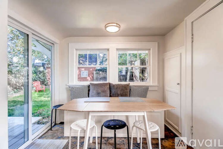 A dining room with a table and chairs.