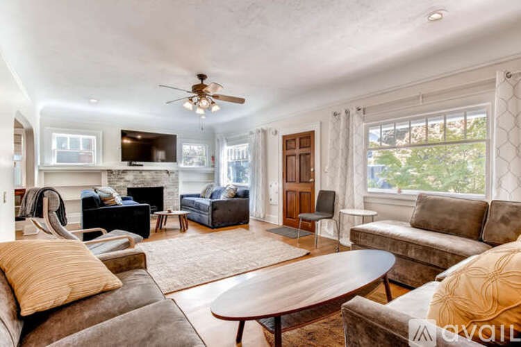 A living room with a brown couch and a wooden coffee table.