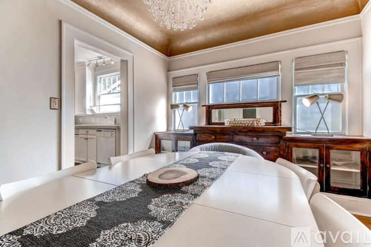 A bedroom with a large bed and a chandelier.