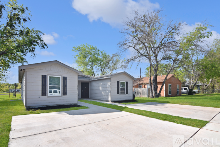 Two houses are shown with a driveway in between.