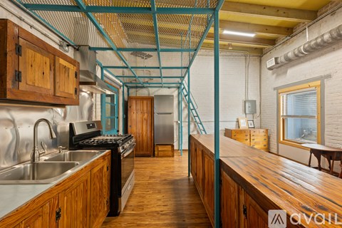 A kitchen with wooden cabinets and a metal stove top oven.