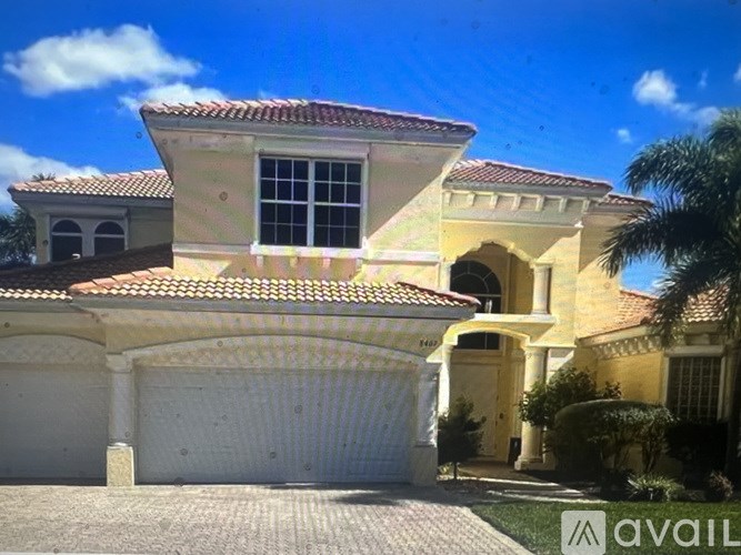 A house with a red tile roof and a white garage door.