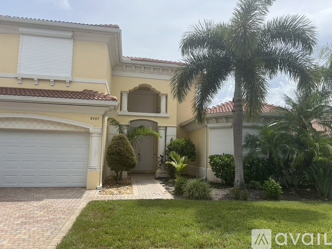 A house with a palm tree in front.
