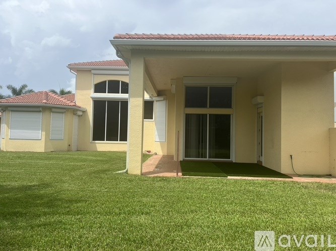 A house with a red tile roof and a beige exterior is available for rent.