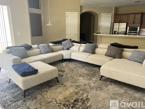 A living room with a large sectional sofa and a chaise lounge.