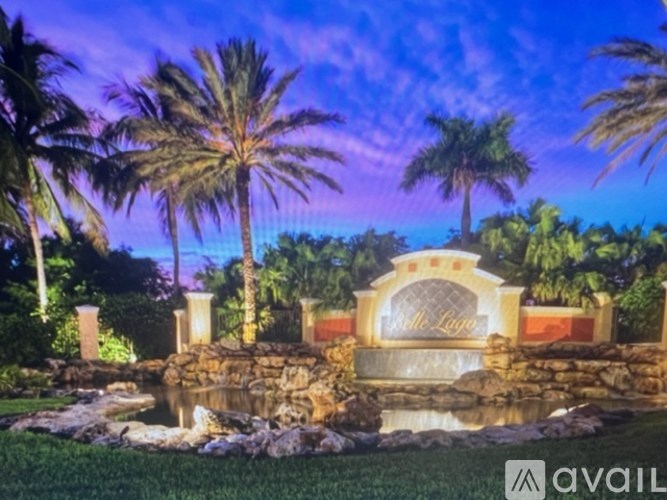 A beautiful garden with a fountain and palm trees.