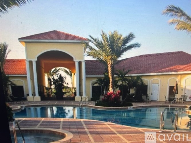 A house with a pool in front of it.