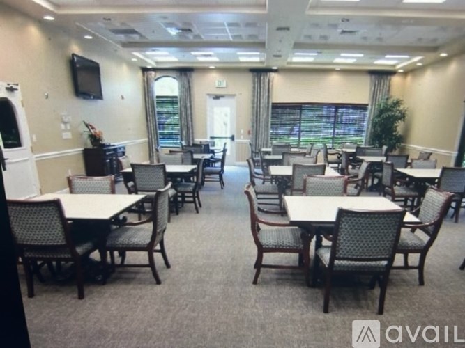 A conference room with multiple tables and chairs.