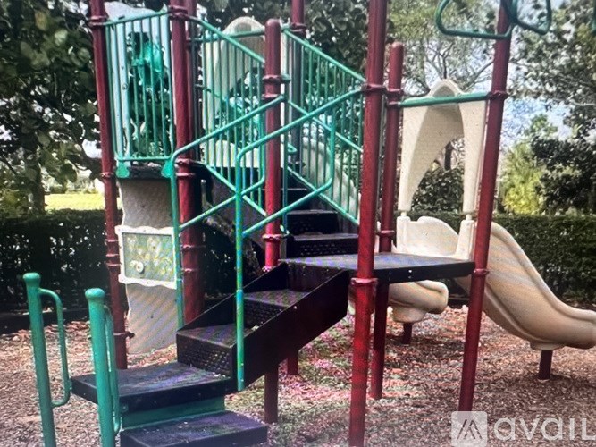 A playground with a slide, stairs and a climbing frame.