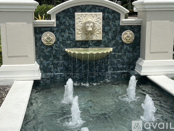 A fountain with a face decoration in the middle.
