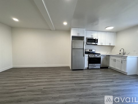 A kitchen with white cabinets and stainless steel appliances.
