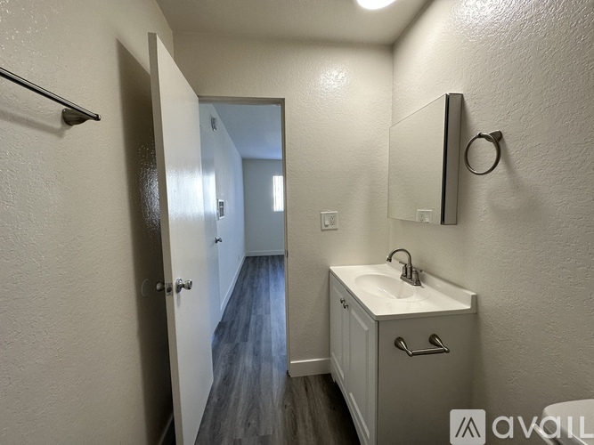 A bathroom with a sink and mirror.