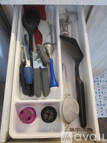 A drawer full of utensils including spoons, spatulas, and tongs.