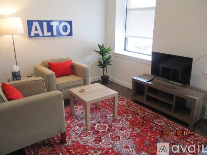 A living room with a couch, chair, and a coffee table.