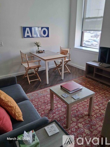 A living room with a couch, chair, and a coffee table.