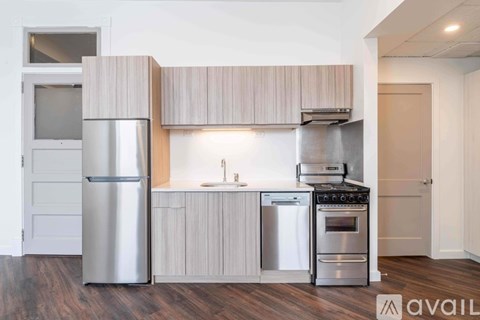 A modern kitchen with wooden cabinets and stainless steel appliances.