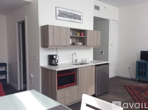 A kitchen with a white countertop and a microwave oven.