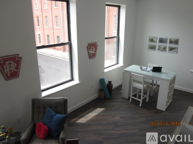 A room with a desk and a chair in it.