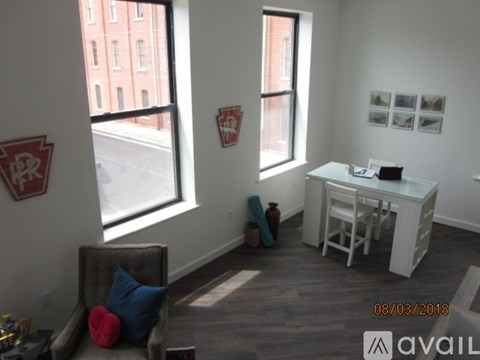 A room with a desk and a chair in it.