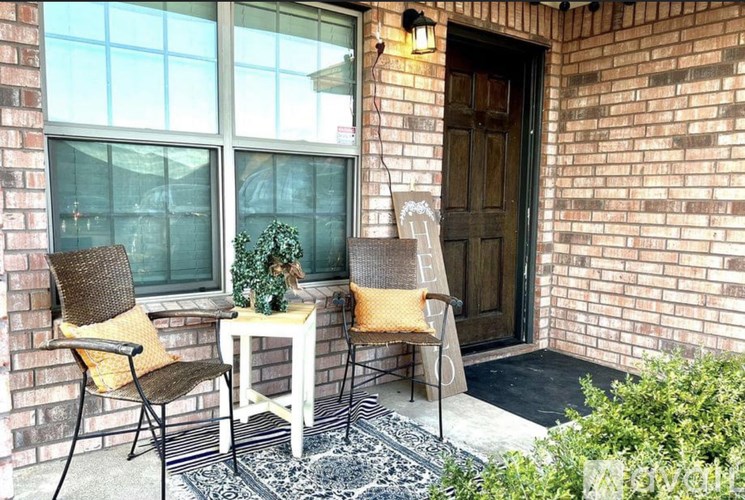 A patio with a table and two chairs.