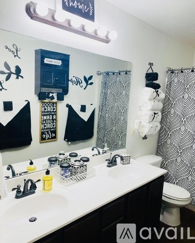 A bathroom with a white sink and a toilet.