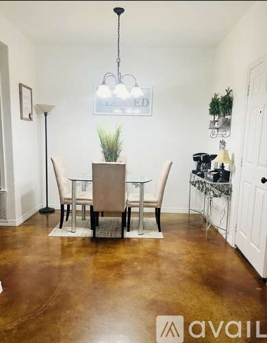 A dining room with a table set for four.