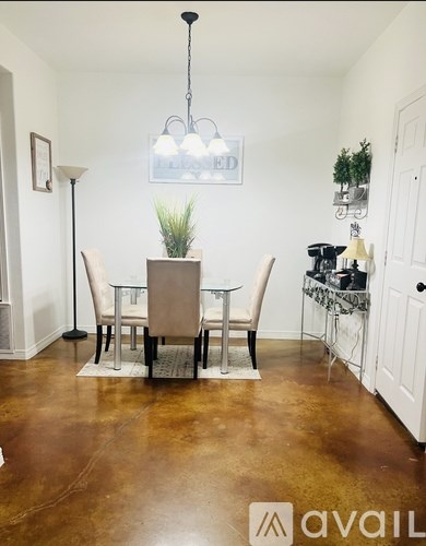 A dining room with a table set for four.
