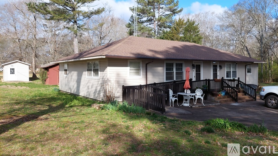 A house with a red door and a patio with chairs.