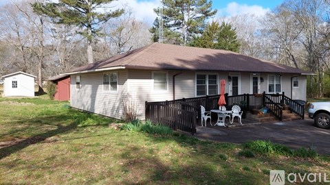 A house with a red door and a patio with chairs.