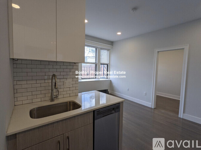 A kitchen with a sink and a window.