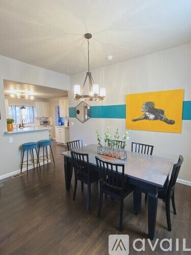 A dining room with a table set for four.