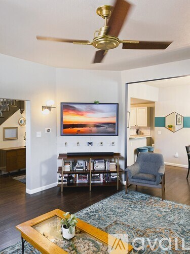 A living room with a television and a chair.