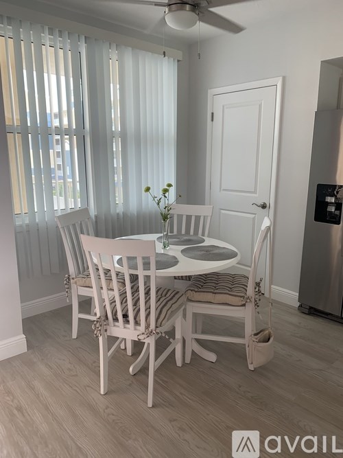 A dining room with a table set for four.