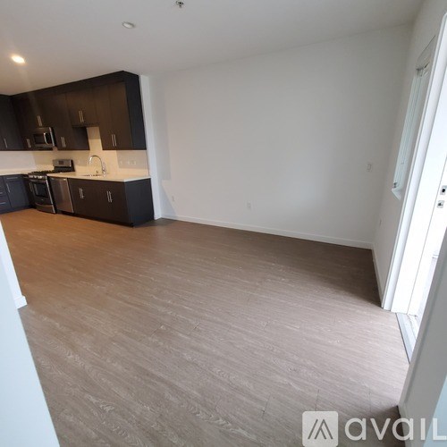 A kitchen with dark brown cabinets and a white countertop.