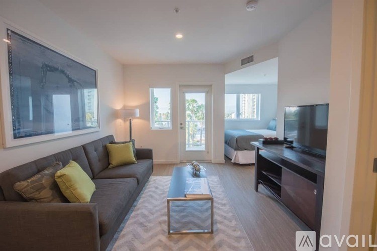 A living room with a grey couch and a coffee table.