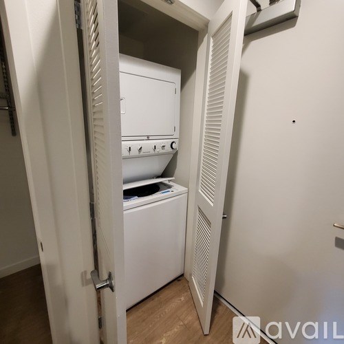 A white washing machine and dryer in a small laundry room.