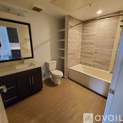 A bathroom with a toilet, sink, and bathtub.