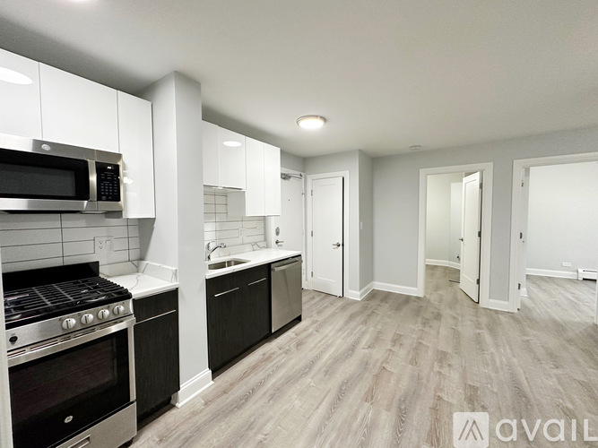 A kitchen with a stove, oven, and microwave.