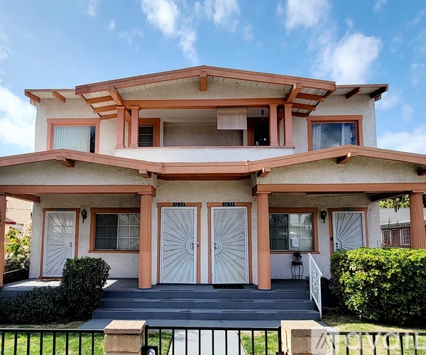 A two-story house with a peach facade and white trim.
