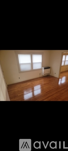 A room with wooden floors and a window.
