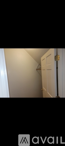 A white door is in a narrow hallway.