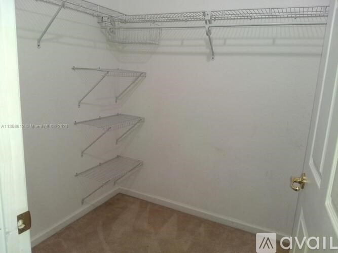 Empty white shelving unit in a room.