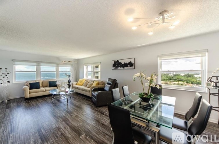 A living room with a glass table and chairs.