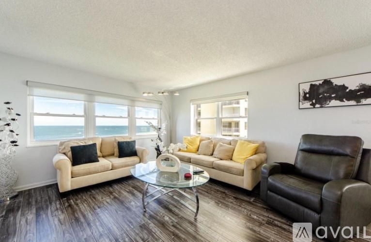 A living room with a couch, chair, and coffee table.