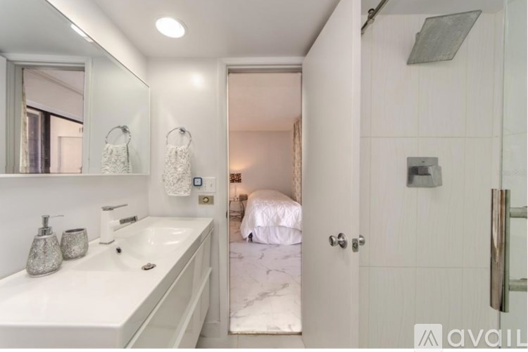 A bathroom with a white sink and a mirror above it.