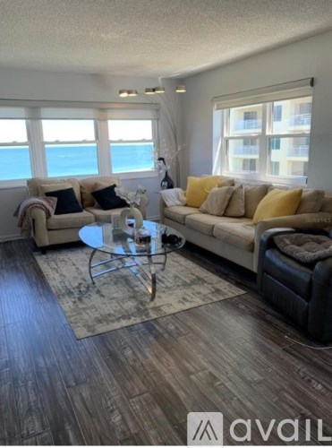 A living room with a glass table and a couch.